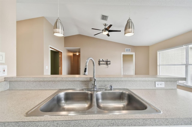 kitchen with sink, ceiling fan, lofted ceiling, and pendant lighting