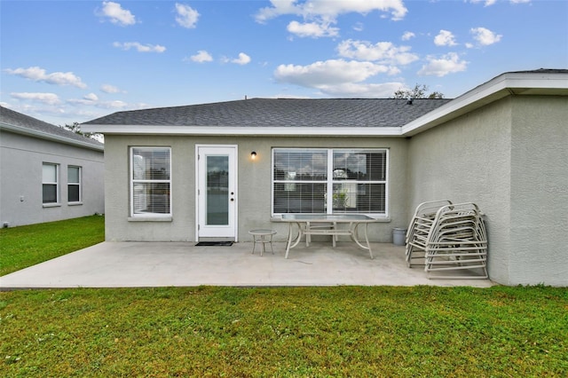 rear view of house featuring a yard and a patio area