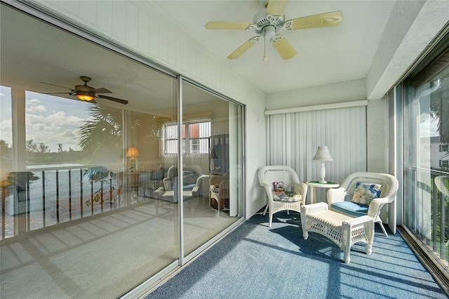 sunroom / solarium featuring ceiling fan