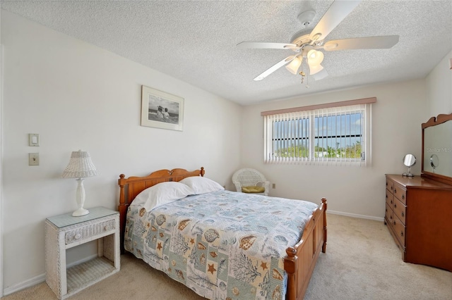 carpeted bedroom featuring a textured ceiling and ceiling fan