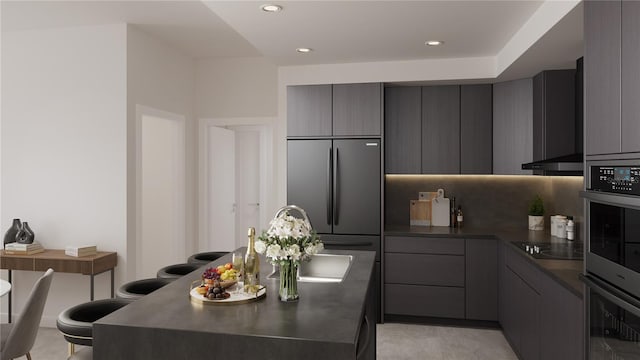 kitchen featuring gray cabinetry, built in fridge, backsplash, and black electric stovetop