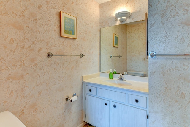 bathroom featuring vanity and toilet