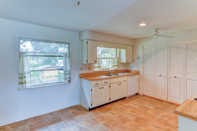 kitchen with dishwasher, white cabinetry, a textured ceiling, and ceiling fan