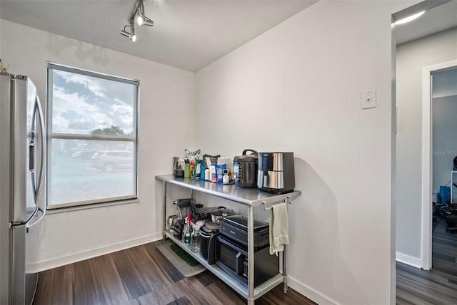 interior space featuring dark hardwood / wood-style floors and stainless steel refrigerator with ice dispenser