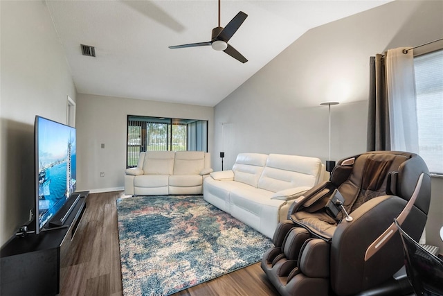 living room with ceiling fan, dark wood-type flooring, and vaulted ceiling