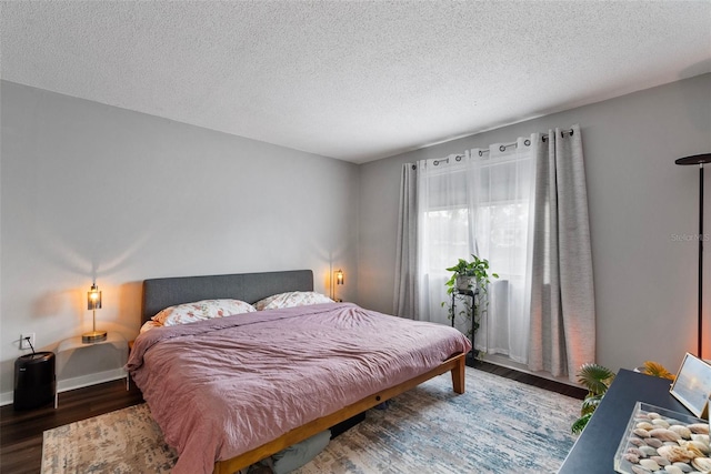 bedroom featuring hardwood / wood-style floors and a textured ceiling