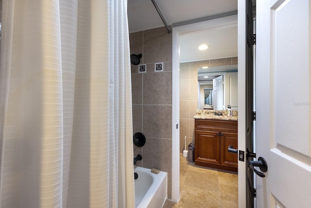 bathroom with vanity, tile walls, and shower / tub combo with curtain