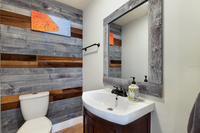 bathroom featuring tile patterned floors, vanity, and toilet