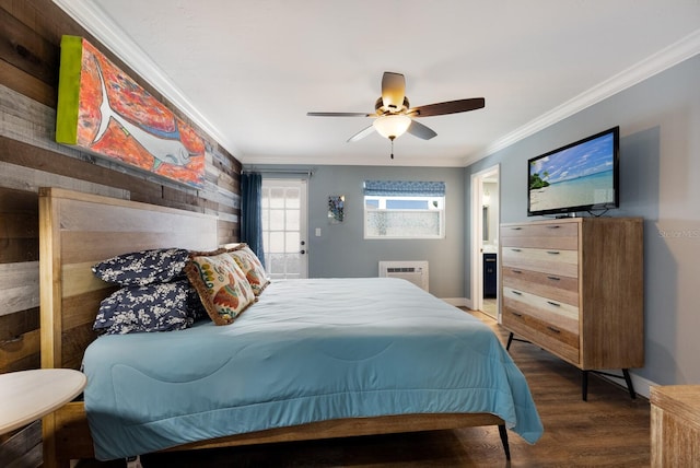 bedroom featuring ceiling fan, dark hardwood / wood-style floors, crown molding, and connected bathroom