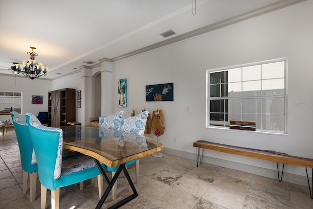 dining space with ceiling fan with notable chandelier and ornamental molding