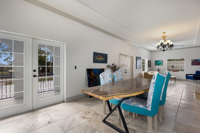 dining area featuring french doors and an inviting chandelier