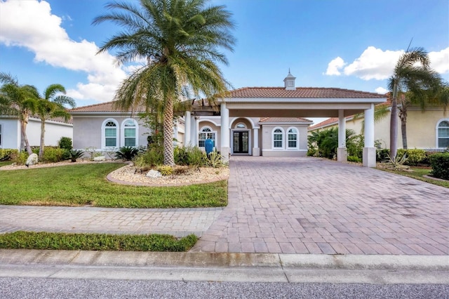 575 Fore Dr, Bradenton, FL 34208 - view of front of house featuring french doors, stucco siding, decorative driveway, a tile roof, and a front lawn