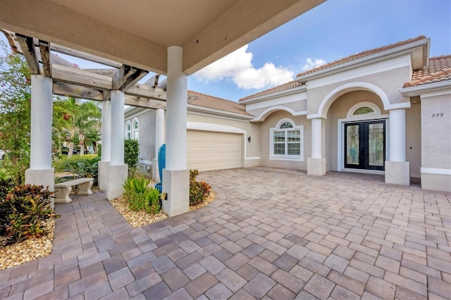 view of patio with a garage and french doors