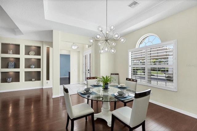575 Fore Dr, Bradenton, FL 34208 - dining space with wood finished floors, ornamental molding, a raised ceiling, french doors, and a chandelier