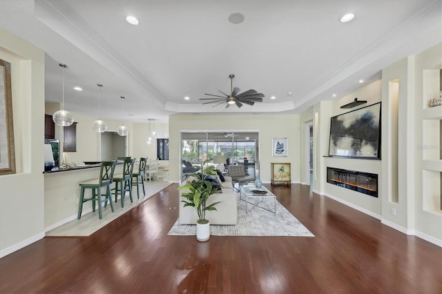 575 Fore Dr, Bradenton, FL 34208 - living room featuring wood finished floors, a tray ceiling, recessed lighting, a ceiling fan, and ornamental molding