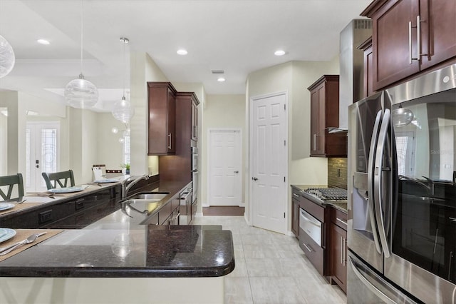 kitchen with dark stone counters, sink, appliances with stainless steel finishes, tasteful backsplash, and decorative light fixtures