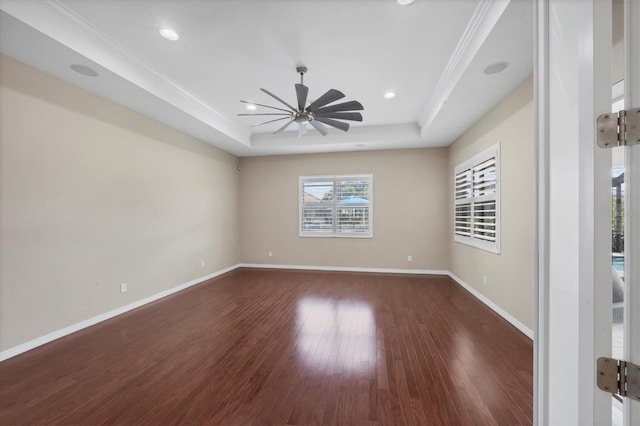 575 Fore Dr, Bradenton, FL 34208 - spare room featuring a raised ceiling, dark wood-style floors, a ceiling fan, baseboards, and ornamental molding