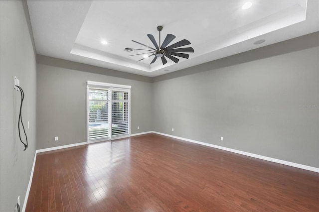 575 Fore Dr, Bradenton, FL 34208 - spare room with a tray ceiling, ceiling fan, dark wood-style flooring, baseboards, and recessed lighting