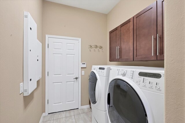 575 Fore Dr, Bradenton, FL 34208 - washroom featuring washing machine and dryer, cabinet space, light tile patterned floors, baseboards, and electric panel