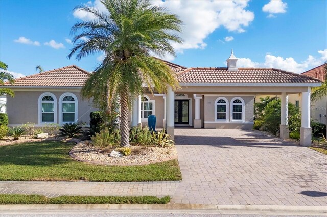 575 Fore Dr, Bradenton, FL 34208 - mediterranean / spanish house with a tile roof, stucco siding, and french doors