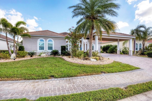 575 Fore Dr, Bradenton, FL 34208 - mediterranean / spanish home with decorative driveway, stucco siding, a front lawn, a carport, and a tile roof