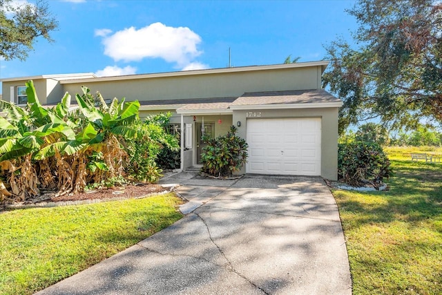 view of front of home with a garage and a front lawn