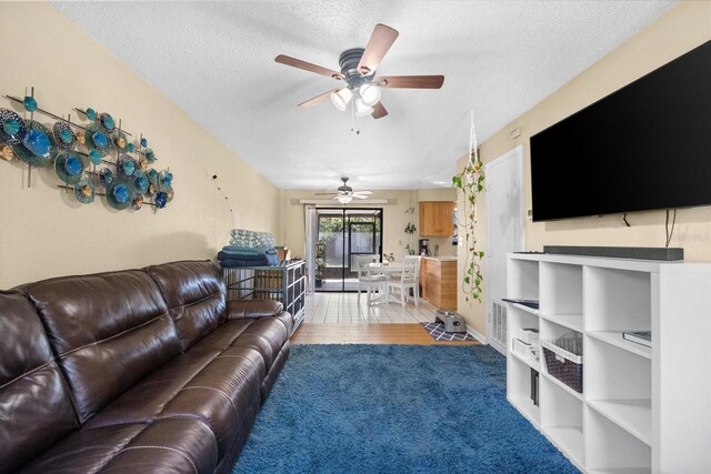 living room with hardwood / wood-style flooring and a textured ceiling