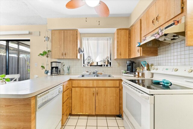 kitchen featuring white appliances, sink, decorative backsplash, light tile patterned floors, and kitchen peninsula