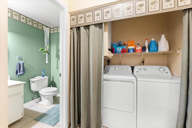 laundry room with light tile patterned flooring and independent washer and dryer