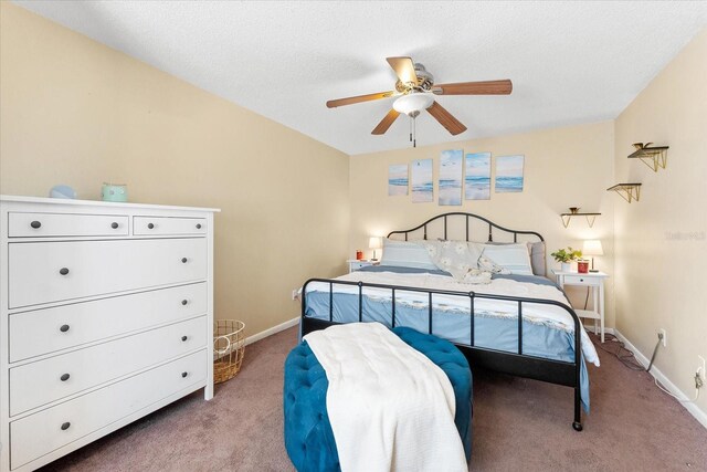 carpeted bedroom with ceiling fan and a textured ceiling