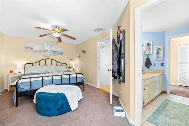 carpeted bedroom featuring a textured ceiling and ceiling fan