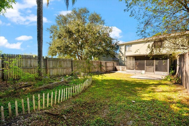 view of yard featuring a sunroom