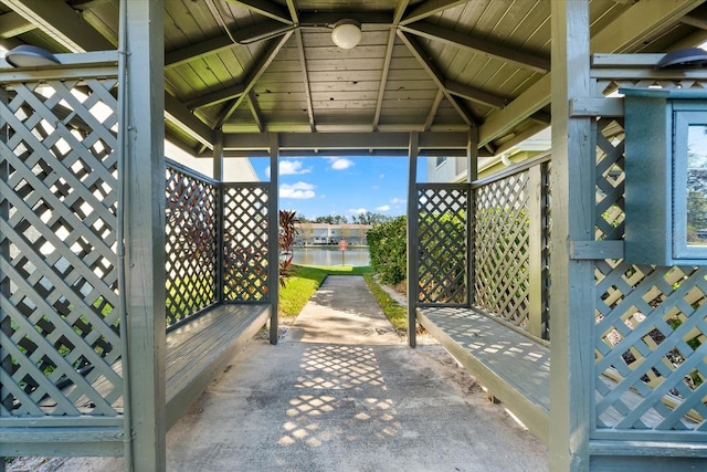 view of patio featuring a gazebo and a water view