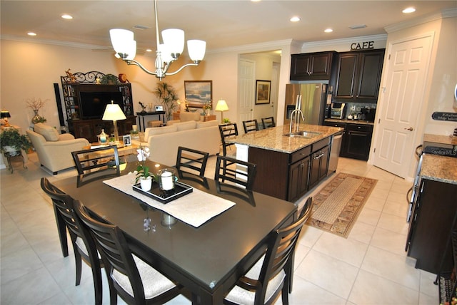 dining room with light tile patterned floors, a chandelier, sink, and crown molding