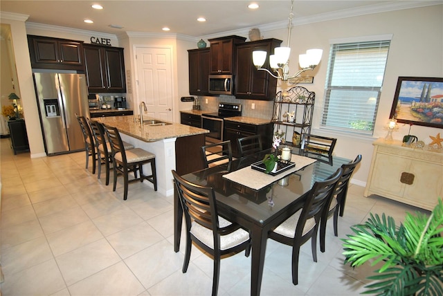 dining room featuring ornamental molding, light tile patterned floors, sink, and an inviting chandelier