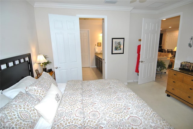 bedroom with light carpet, crown molding, and ensuite bathroom