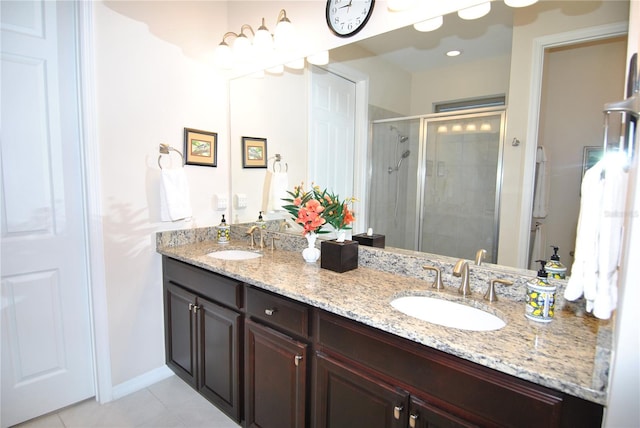 bathroom featuring tile patterned flooring, vanity, and a shower with shower door