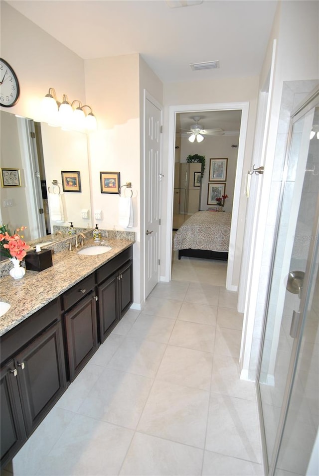 bathroom with vanity, ceiling fan, tile patterned floors, and a shower with shower door