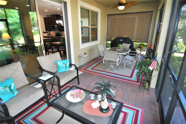 sunroom / solarium with ceiling fan