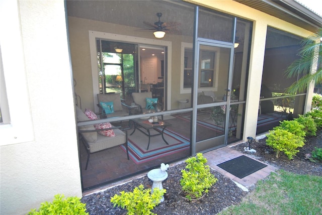 doorway to property with ceiling fan