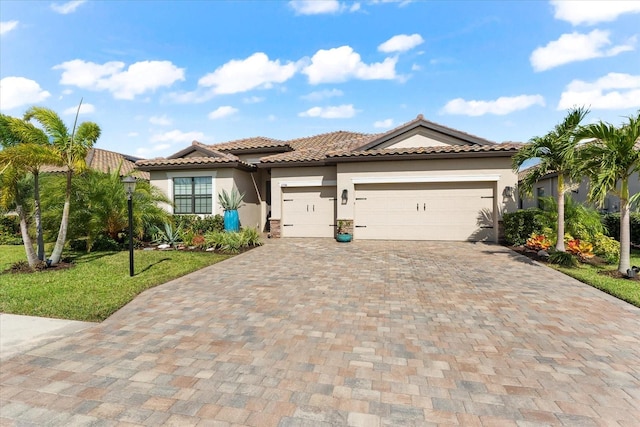 mediterranean / spanish home with a garage and a front yard