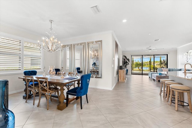 dining space featuring ceiling fan with notable chandelier, light tile patterned flooring, and crown molding