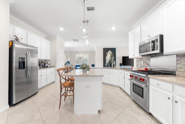 kitchen featuring light stone countertops, backsplash, stainless steel appliances, a center island, and a breakfast bar area