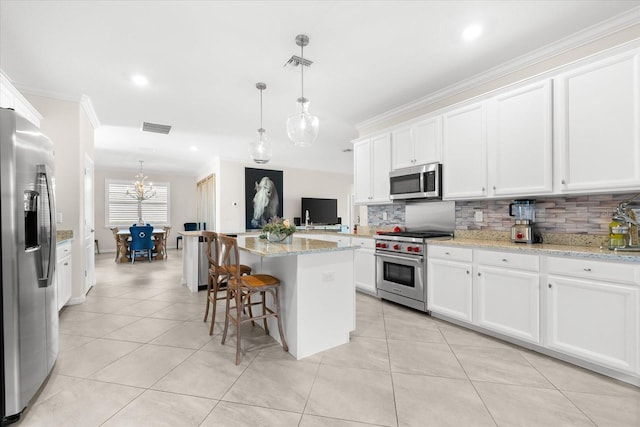 kitchen featuring pendant lighting, a center island, white cabinetry, and stainless steel appliances