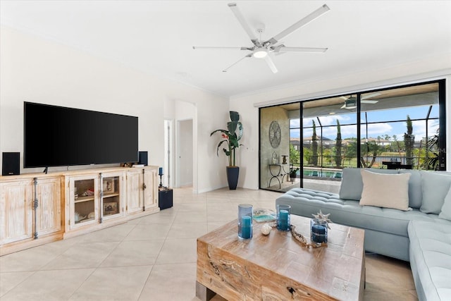 living room with ceiling fan, light tile patterned floors, and crown molding