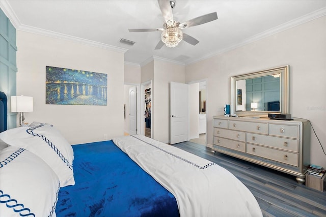 bedroom featuring ceiling fan, dark hardwood / wood-style floors, ornamental molding, and a closet