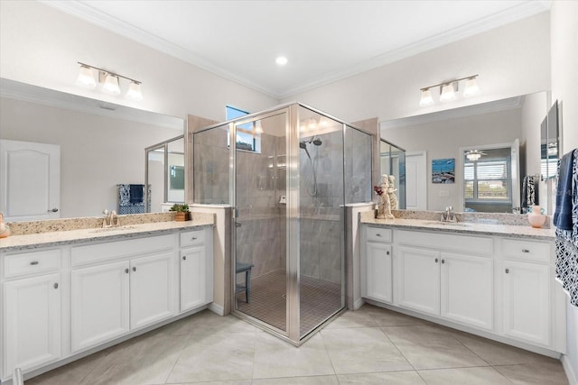 bathroom with tile patterned flooring, vanity, a shower with shower door, and crown molding