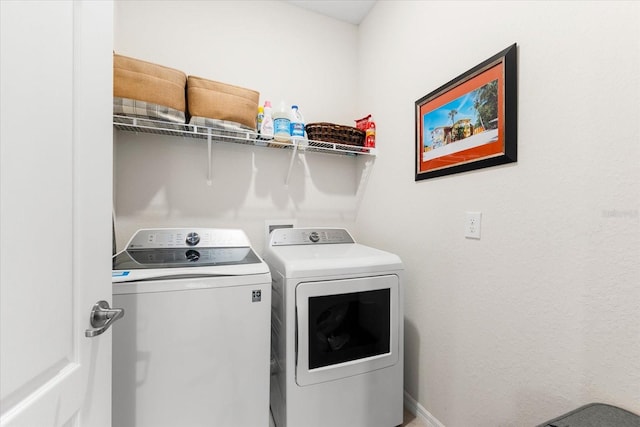 clothes washing area with separate washer and dryer