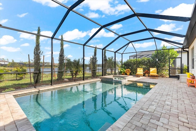 view of swimming pool featuring glass enclosure, a patio area, and an in ground hot tub