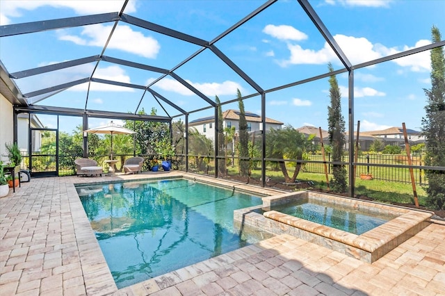 view of pool with an in ground hot tub, a patio, and glass enclosure